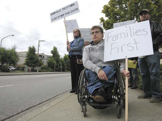 Kimberley Yanko (background) and her son Daniel (in front) were part of a protest at Social Development Minister Harry Bloy's office in Burnaby on Wednesday.