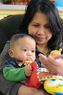 All in the family: Elena Gerarcas and Liam, six months, at New Westminster Family Place. The non-profit group is looking for donations of toilet paper and apple juice for drop-in programs.