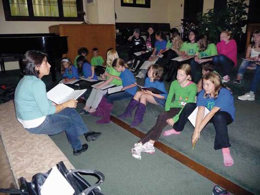 Learning: Director Anne Wilson Unger leads some of the older choristers at Vivo in learning some new music.