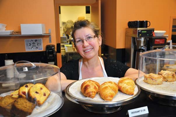 Service with a smile: Rizida Baikova enjoys serving up sweet treats and other delicacies at Belmont Bakery and Bistro in uptown New Westminster. Russian fare like piroshkys are on the menu.