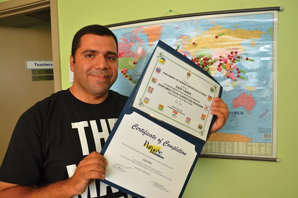 Around the world: Zaid Taher, who moved to Canada from Iraq seven months ago, proudly shows the certificate he received for completing the Newcomer Youth Connection program. In the past three years, more than 290 clients from 45 different countries have helped adjust to life in Canada by taking the three-month program.