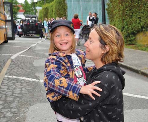 Happy camper: Ginny sends six-year-old Angel off to camp for the first time. Angel is one of more than 70 kids heading to Burn Camp at Camp Latona on Gambier Island, where they will enjoy activities including swimming, hiking, kayaking, a skit night and arts and crafts.