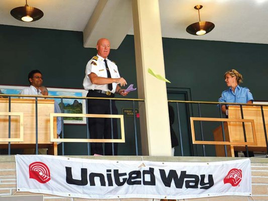Going in for a landing: Deputy fire chief Brent Wisheart watches to see where his paper airplane lands as it heads toward a target in the foyer of city hall.