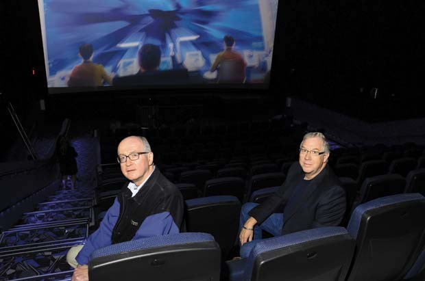 Comfy seats: Landmark Cinemas owners Brian McIntosh, left, and Neil Campbell check out the seats that tilt back for a comfortable movie-going experience at the new theaters in New Westminster.