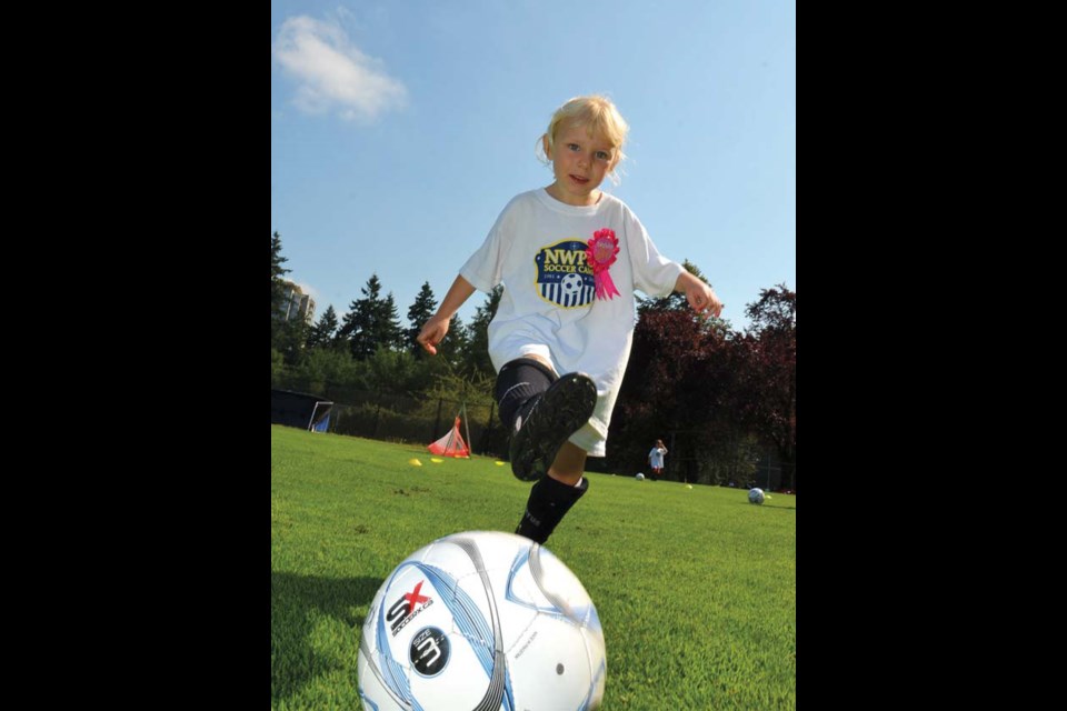 Olivia Shepherd, six, celebrates her birthday on Wednesday at the New Westminster Police Department's annual soccer camp. Shepherd and older brother Alexander came from Switzerland to attend the popular camp, which concludes Friday.