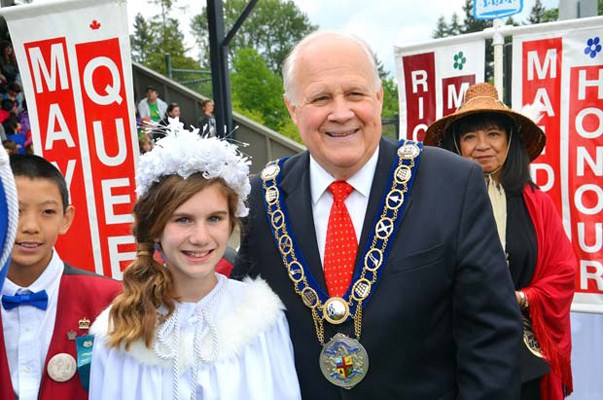 Bidding farewell: Leah Binns' reign as New Westminster's May Queen came to an end on Wednesday. Mayor Wayne Wright escorted Leah to the stage at Queen's Park Stadium for Wednesday's festivities.