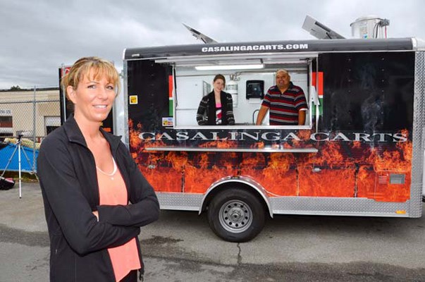 Good eats: Trish Bell, left, owner of Casalinga Food Services, will bring her 14-foot food cart to the Columbia StrEAT food truck festival in New West this summer. Bell's daughter, Jessica Skews, and employee Gundher Ortiz are also on board for the festival.