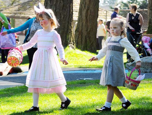 Easter finery: Sisters Lauren and Olivia stroll through Easter in Queen's Park in their Easter outfits, after a visit with the face painter.