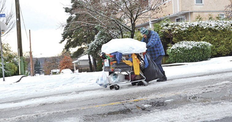 A local man finds it tough sledding as he pushes his shopping cart along an icy Royal City street.
