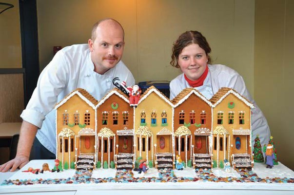 Home, sweet home: NWSS culinary arts instructor Stephen Schram, left, "coached" Charlotte Gurney-Banning with the gingerbread house she made for the Hyatt gingerbread contest. Charlotte was inspired to start the project after her mom gave her a cookbook for her birthday in September this year.
