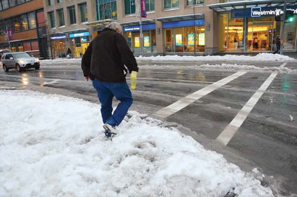 Brrrrr: Snow plus rain equals boot weather as this New Westminster pedestrian discovered Wednesday after a second day of inclement weather created problems in the city. The closure of the new Port Mann bridge added to the city's challenges as commuters were re-routed through the city. Warmer weather, and rain, of course, is predicted for this weekend.