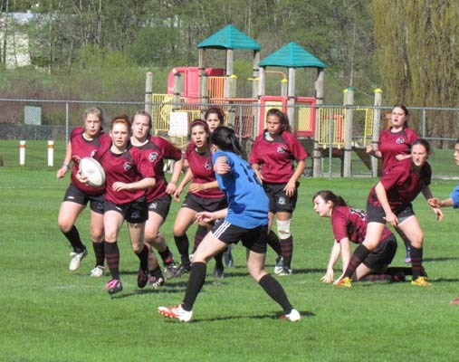 Charging forward: Ruby Moore-Kalia, with the ball, runs a breakaway play for Burnaby North Secondary during a game against McMath Secondary April 22; Burnaby defeated McMath 32-0.