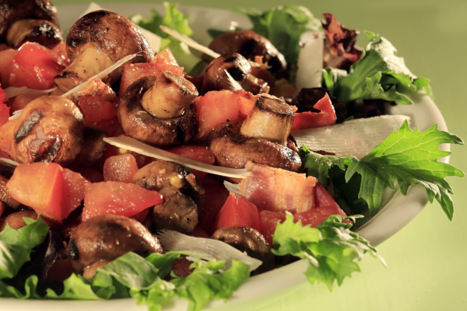 Many foods are naturally laden with glutamate, including this salad with bacon, mushrooms and tomatoes served on a bed of greens. It can be served as an entre, a side dish or as a topping for grilled steak.