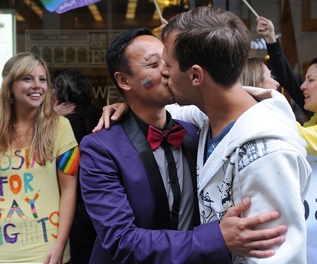 Yogi Omar (left), organizer of the Global Kiss-In Protest, kisses friend Ryan Clayton outside the Russian consulate on Howe Street last Friday afternoon to protest recently passed anti-gay laws in Russia. Clayton made the trip from Victoria to support his long-time friend's Kiss-In.