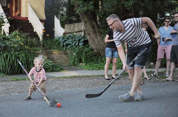 Beau Peterson doesn't let a slightly too-large stick get in the way of going for the orange ball during Rose Street Block Party street hockey action Saturday, July 6th 2013.