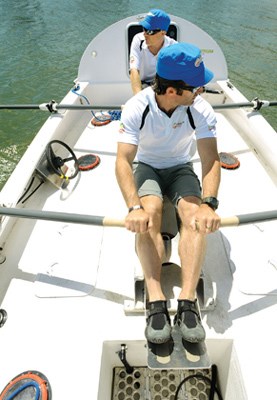 Paul Gleeson (front) and Kevin Vallely row The Arctic Joule in
English Bay prior to the Mainstream Last First expedition launch. The ship's
wheel can be operated by hand or foot to control the rudder system.