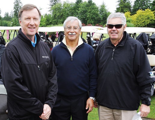 Credit union vice-president, finance, and chief financial officer Bill Keen with Amir Ahamed and Dennis Holmes