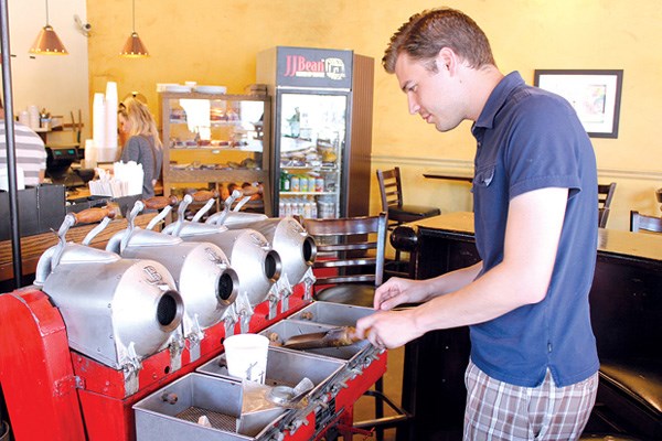 Grady Buhler, of JJ Bean Coffee checks out some coffee beans ready to be roasted.