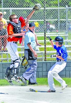 West Van's #14 Owen Cotterill (blue) makes it home safe as Lynn Valley catcher Hudson Schandor attempts a catch during game at Chris Zuehlke Park in District Little League tournament semifinal.