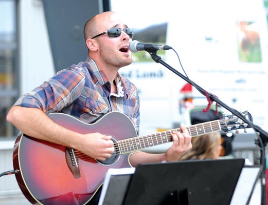 Mark Farrer entertains June 28 at the Friday Night Market at Shipyards Plaza at the foot of Lonsdale Avenue.