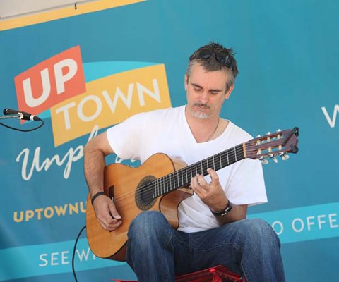 Strumming a tune: Doug Towle performs at the opening weekend of Uptown Unplugged, at in the plaza in front of Westminster Centre at 555 Sixth St. The mall is inviting community members to have a seat and watch entertainment every Saturday and Sunday between 12 and 5 p.m.
