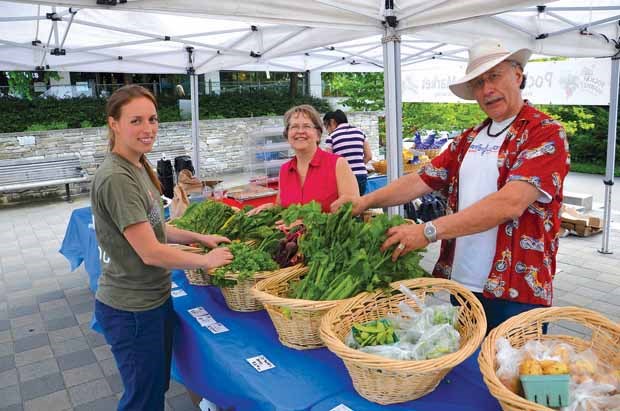 Gorgeous greens: Charlotte Fesnoux, left, and Dolores and Bill Storness-Bliss display goods at the SFU Pocket Farmers' Market. This is the sixth season of the market, which is held at the Town Square at Cornerstone (by the transit loop). It is held every Wednesday, from 11 a.m. to 5 p.m. until October.