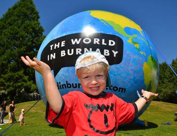 Celebrating community: Three-year-old Dylan Jones holds up the whole world at Burnaby Village Museum during B.C. Day festivities. The World in Burnaby display is part of a campaign to help foster kinship and community in the city by welcoming and connecting with newcomers, immigrants and refugees.