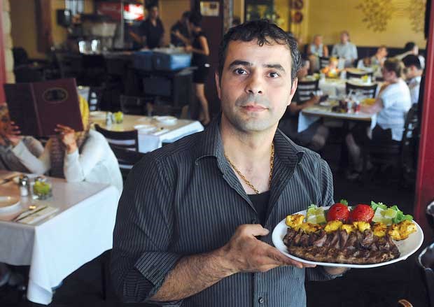 Cazba Restaurant manager Reza Varasteh displays a plate of Persian kebabs. Photograph Paul McGrath, North Shore News