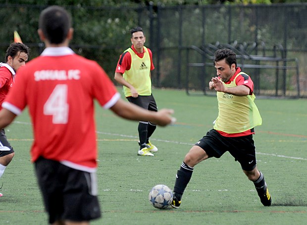 Members of the Soheil FC (red) and Shaheen FC (yellow) compete on the Confederation Park field during the 15th Annual "Friendship Cup Tournament" in North Vancouver.