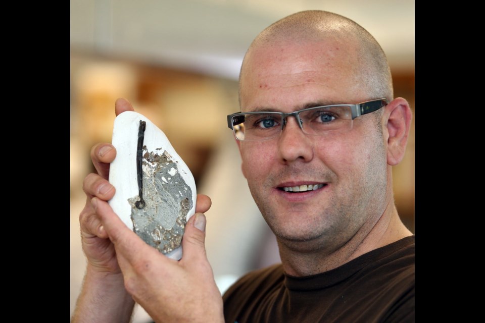 Victoria’s Steve Suntok with the 25-million-year-old fossilized bird bone he unearthed in the intertidal zone of the Carmanah rock groups, near Sooke. He has donated the fossil to the Royal B.C. Museum.