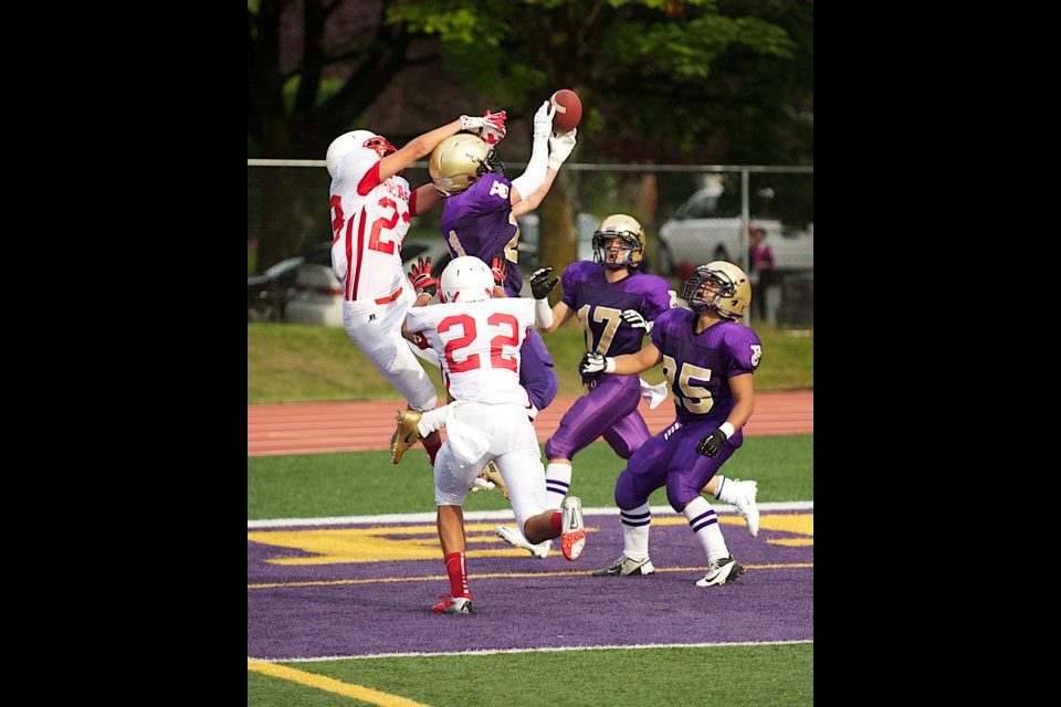 Fighting Irish defensive back Andrew Alie-Day takes to the air to intercept a touchdown pass to thwart the Bears Sept. 6 at O'Hagan Field. Damian Mauro (No. 17) and Justin Angeles (25) are in on the play.