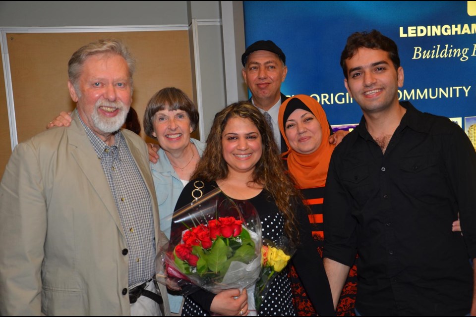 Marwa O'da, 26, (in centre) was finally reunited with her Burnaby fiance, Wissam Nassar, at right, on Tuesday. She escaped from Syria with the help of a Ian and Heather Macdonald (at left), who led the efforts to sponsor Marwa to come to Canada as a refugee. In rear are Waleed and Suhair Nassar, Wissam's father and mother.