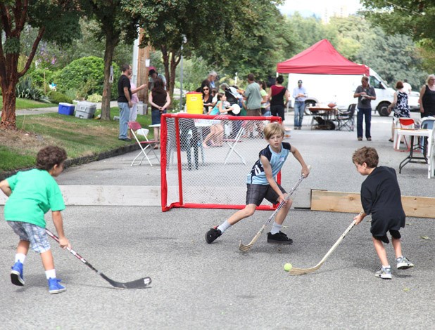 Faceoff fun: Kids enjoy a game of ball hockey at a block party in Sapperton on Sept. 8. It was one of more than 60 local projects to get a neighbourhood small grant from the Vancouver Foundation.