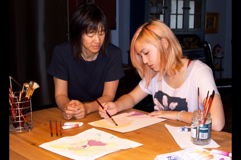 Together: Angela Louie watches daughter India Oates at work on a new project. The two have collaborated on a recently published book, The Possibility Tree.