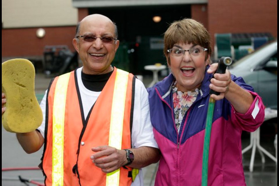 Victoria-Beacon Hill MLA Carole James and Naz Rayani make a splash at the Splish Splash charity car wash for Our Place Society.