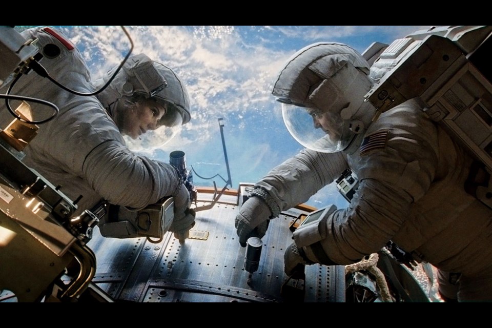 Sandra Bullock and George Clooney are astronauts floating through space with little chance of rescue in Alfonso Cuaron's Gravity.