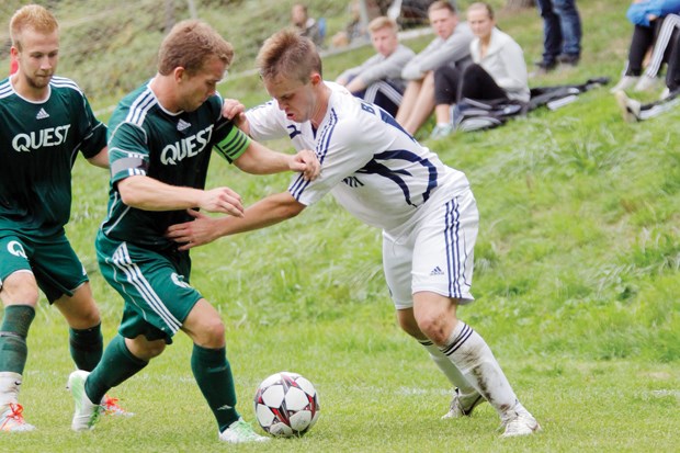 Capilano's Chad De Boer grapples with a Quest defender. De Boer picked the top corner with a left-footed shot at the end of the first half to help lead Capilano to a 4-2 win.