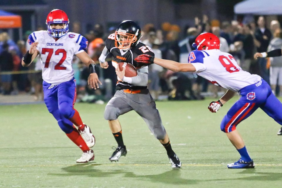 On the run: Hyacks running back Kale Brock evades a tackle during the opening minutes of the Hyacks’ homecoming game against Coquitlam rivals Centennial Centaurs. The Hyacks led the Centaurs by more than 20 points until the fourth quarter.