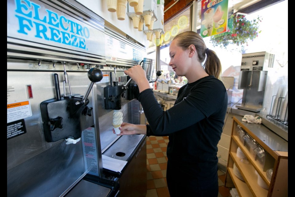 Rhys Rolls-Dewolfe serves ice cream at the Beacon Drive-In, which has been welcoming locals and tourists since 1958.