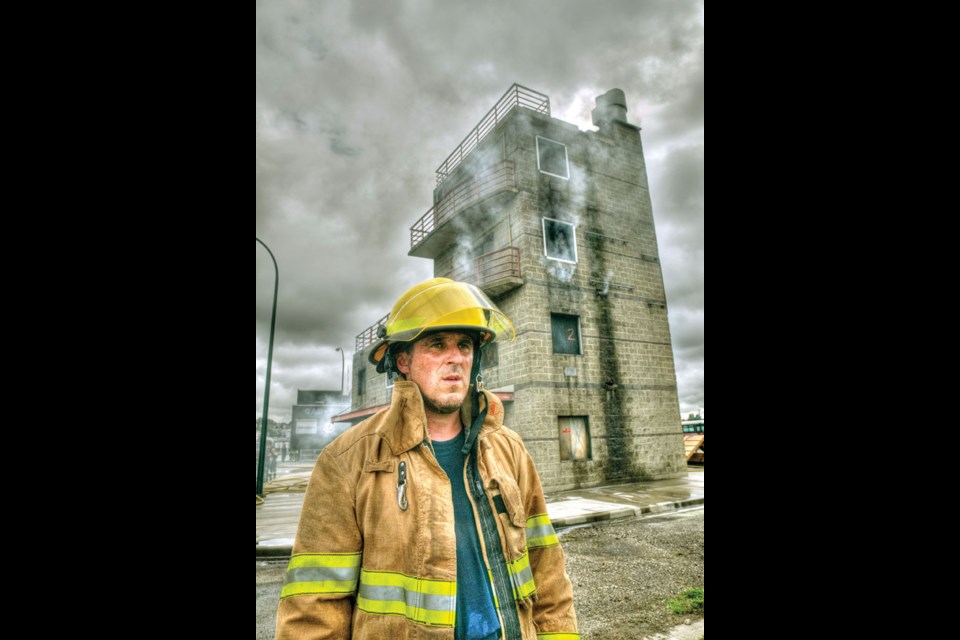 Richmond News reporter Alan Campbell almost loses it while squeezing through a crawl space during a Fire Ops 101 'rescue' mission