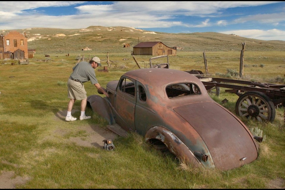 Peter Fay looks over a rusted car at the Bodie State Historical Park.