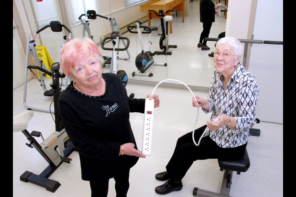 Heartbroken: From left, Helen Mojzes and Eila Astells stand in the spot where their cherished treadmill sat for years. Last week, the women discovered the treadmill they had fundraised to buy had been stolen, but on Friday (today) Astells was told they'd be getting a new one, courtesy of Fitness Town.