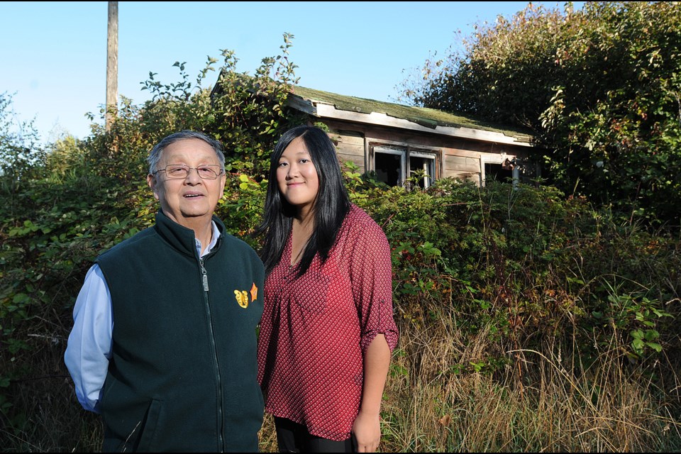 Larry Grant and Sarah Ling in front of one of the last three farmhouses left on Musqueam land. Photo: Dan Toulgoet