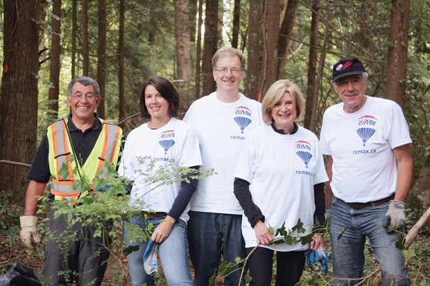 RE/Max Crest Reality North Vancouver branch and Graham Knell, trail and habitat co-ordinator, pull the invasive English ivy from the forest floor at the mouth of Lynn Canyon Park. - The Team: LtoR: Graham Knell,Erin Annesley, Bill Mason, Dale McGauran and Peter Birrell