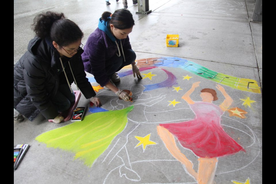 Creative process: Juliana Vieira, left, and her sister Patricia create a chalk picture at the Shadbolt Centre's Art on the Spot event, held to mark Culture Days on Sept. 28.