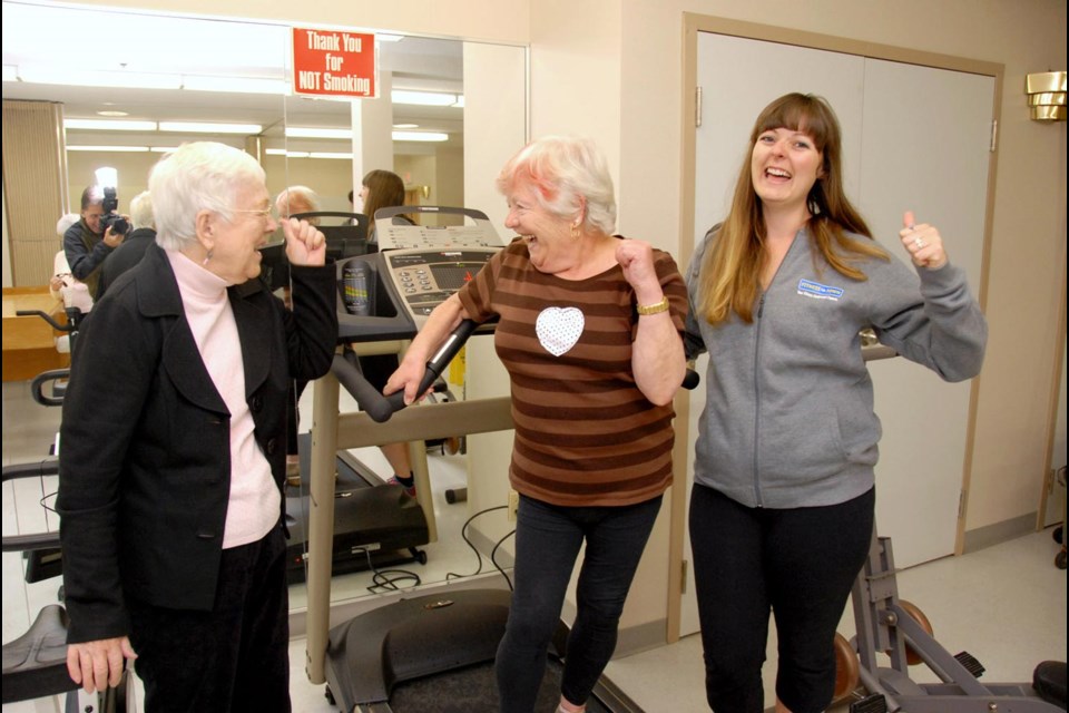 Tread happy: From left, Eila Astells and Helen Mojzes celebrate their brand new treadmill with Fitness Town marketing coordinator Naomi Buell. Fitness Town donated the new treadmill to Gustav Wasa Place seniors’ home after the home’s treadmill was stolen last month.