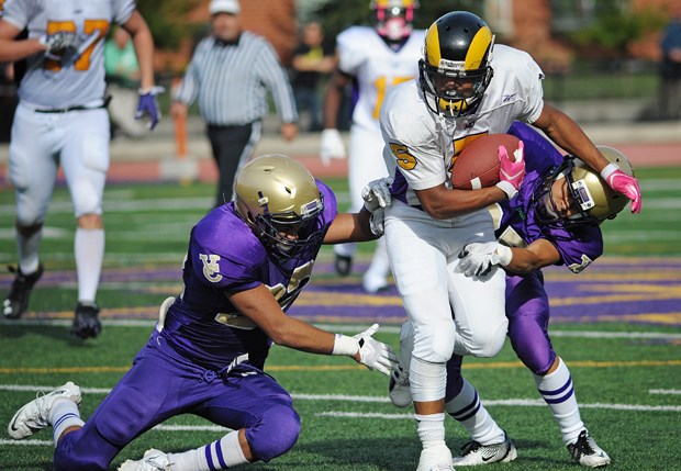 Mt. Douglas running back Marcus Davis powers forward as two Vancouver College tacklers try to haul him to the ground Oct. 5 at O'Hagan Field. The Fighting Irish lost 42-21 to the Rams.