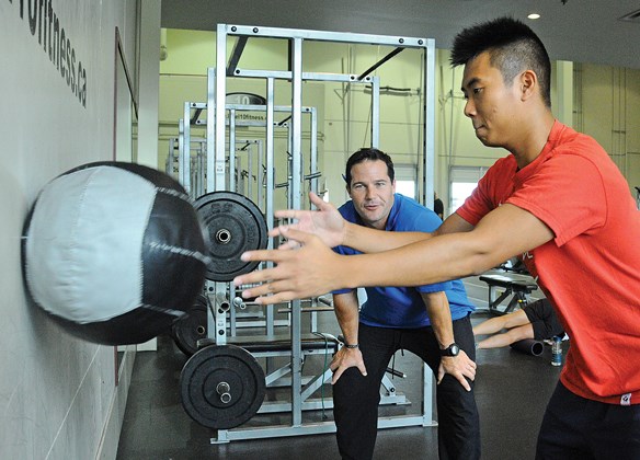Leukemia survivor Brian Lau works out at North Vancouver's Level 10 Fitness with Anthony Findlay, the gym's owner. Lau was granted a wish by the Children's Wish Foundation and chose to take on a personal trainer to improve his health.