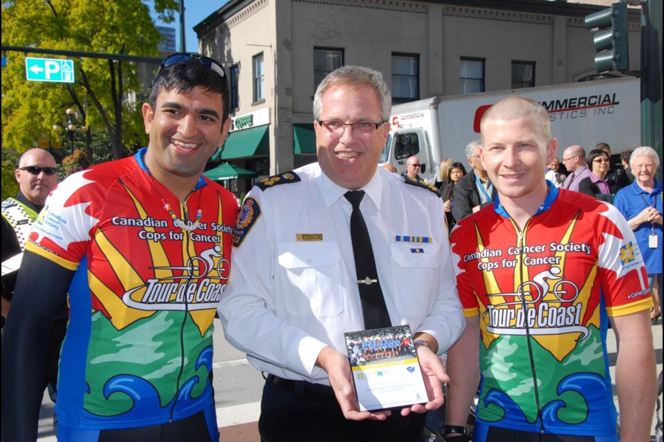 Congratulations: From left, Const. Jaspaul Chung, Chief Const. Dave Jones and Const. Dave Lemire celebrate New Westminster's fundraising efforts for Cops for Cancer. New West representatives, Chung and Lemire, joined Riders from various Lower Mainland police departments in the nine-day Tour de Coast, which started Sept. 18.