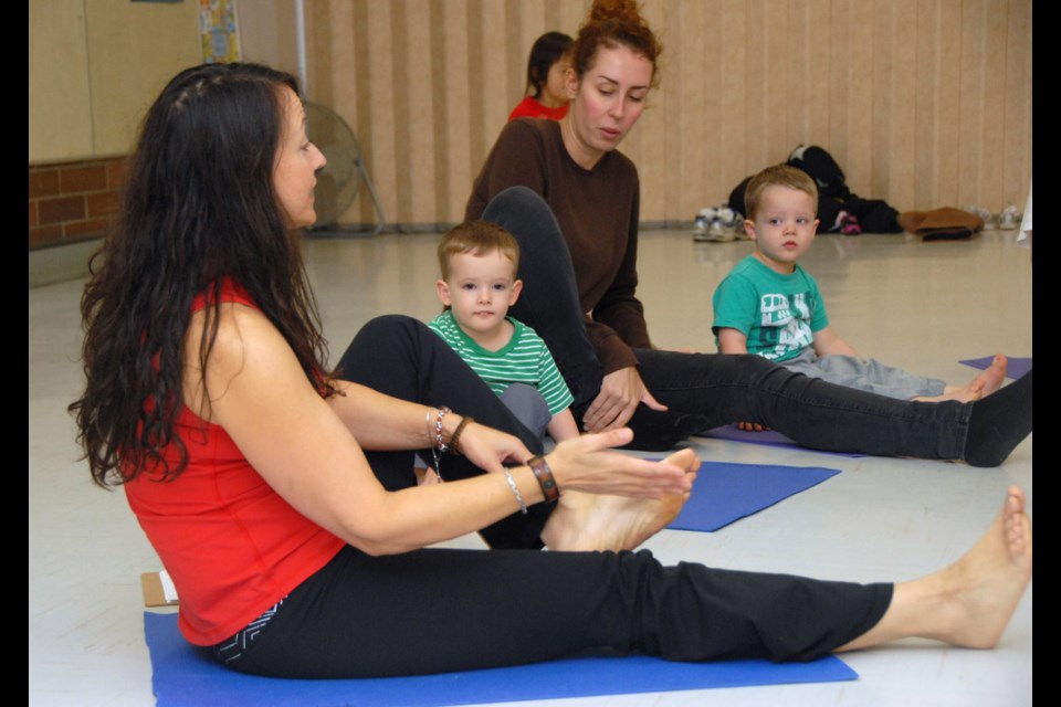 All together now: Teacher Marcia Jones leads Toddler's First Dance class at Cameron Rec Centre. In the background are nanny Kelly Pickford and her twin 2.5-year-old charges, Brandon (in stripes) and Kyle.
